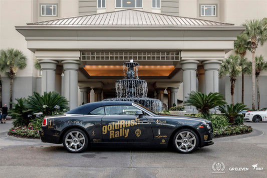 Car with goldRush Rally logo outside of a hotel