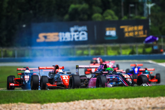 Formula Renault cars compete for position on the track