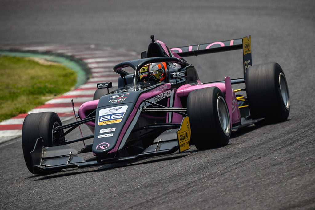 Driver Brendon Leitch on the track in the cockpit of the pink Oloi F3 car