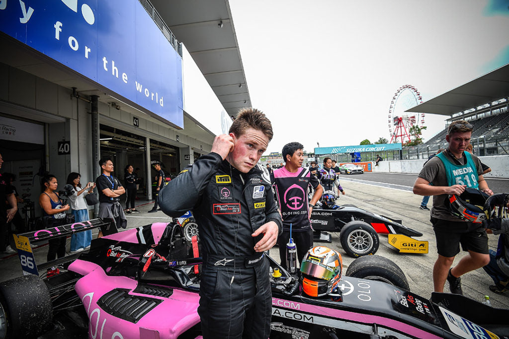 F3 driver Brendon Leitch stands before the pink Oloi F3 car outside its garage